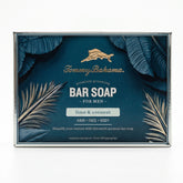 Front of Tommy Bahama Lime & Coconut Bar Soap for Men box featuring gold marlin logo, palm leaf illustration, and "lime & coconut" scent label on teal background