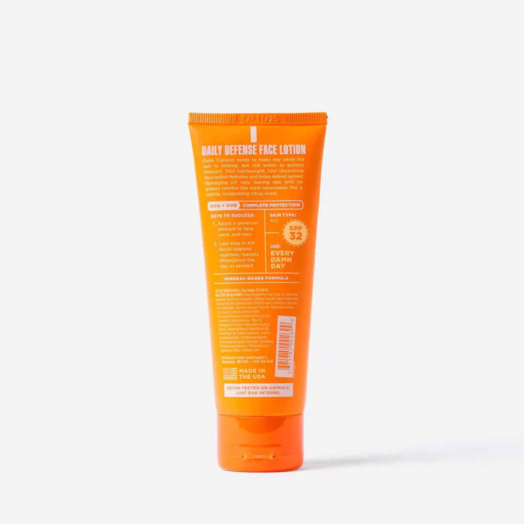 Back of orange tube of Daily Defense Face Lotion on a white background