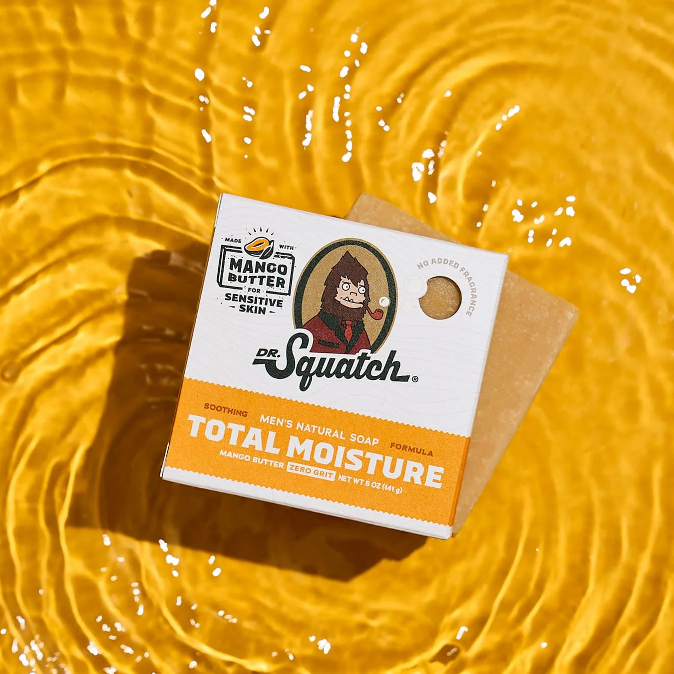 Dr Squatch Mango Butter soap bar on a yellow textured background