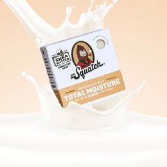 Dr. Squatch soap bar packaging with a splash of milk on a beige background