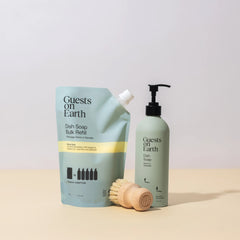 Guests on Earth Dish Soap Starter Kit components: Citrus Oasis refill pouch, reusable bottle, sisal dish brush on beige surface