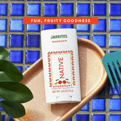 Jarritos Mandarin deodorant on a blue tiled background with 'Fun, Fruity Goodness' text.