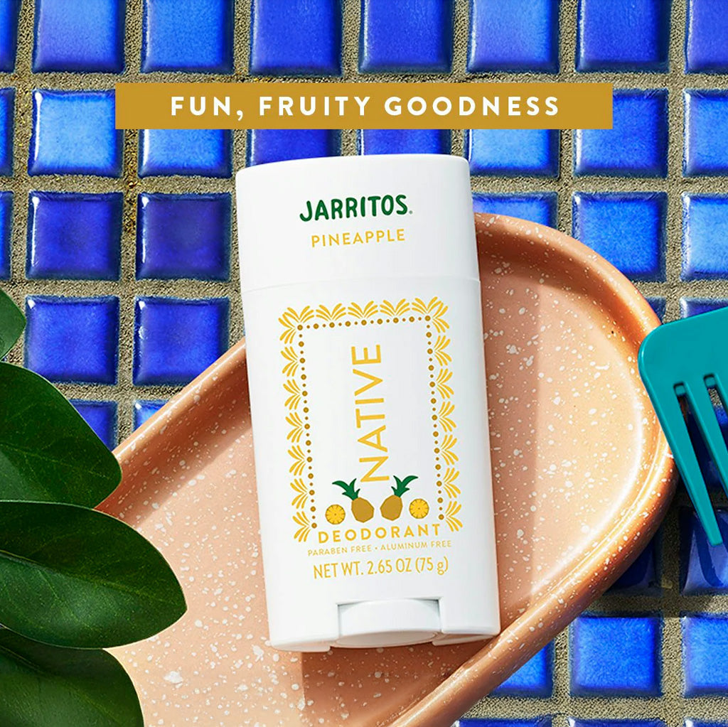 Native Jarritos Pineapple deodorant on a blue tiled background