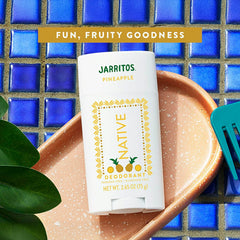 Native Jarritos Pineapple deodorant on a blue tiled background
