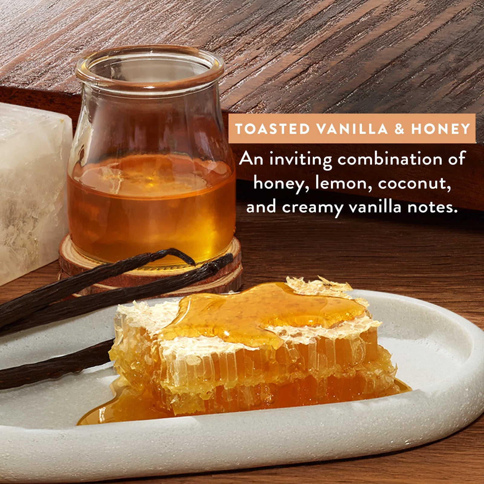 Glass of honey, honeycomb, and vanilla beans on a wooden surface with text describing the flavor profile.