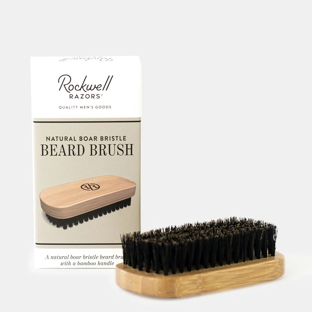 Rockwell natural boar bristle beard brush with bamboo handle displayed against packaging showing quality men's grooming tool for beard care.