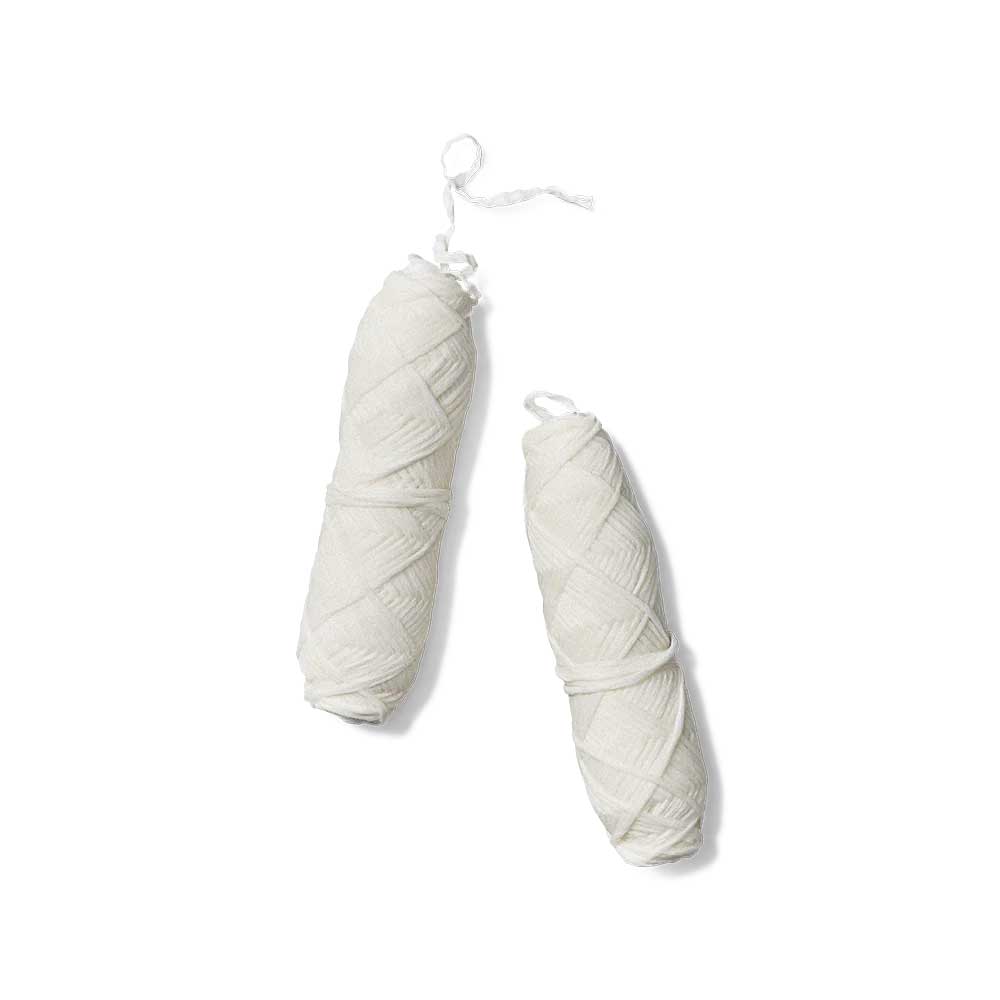 huppy dental floss refills - two white-colored compostable floss spools with braided texture suspended by white strings against minimalist background, showing refill packaging for zero-waste oral care system