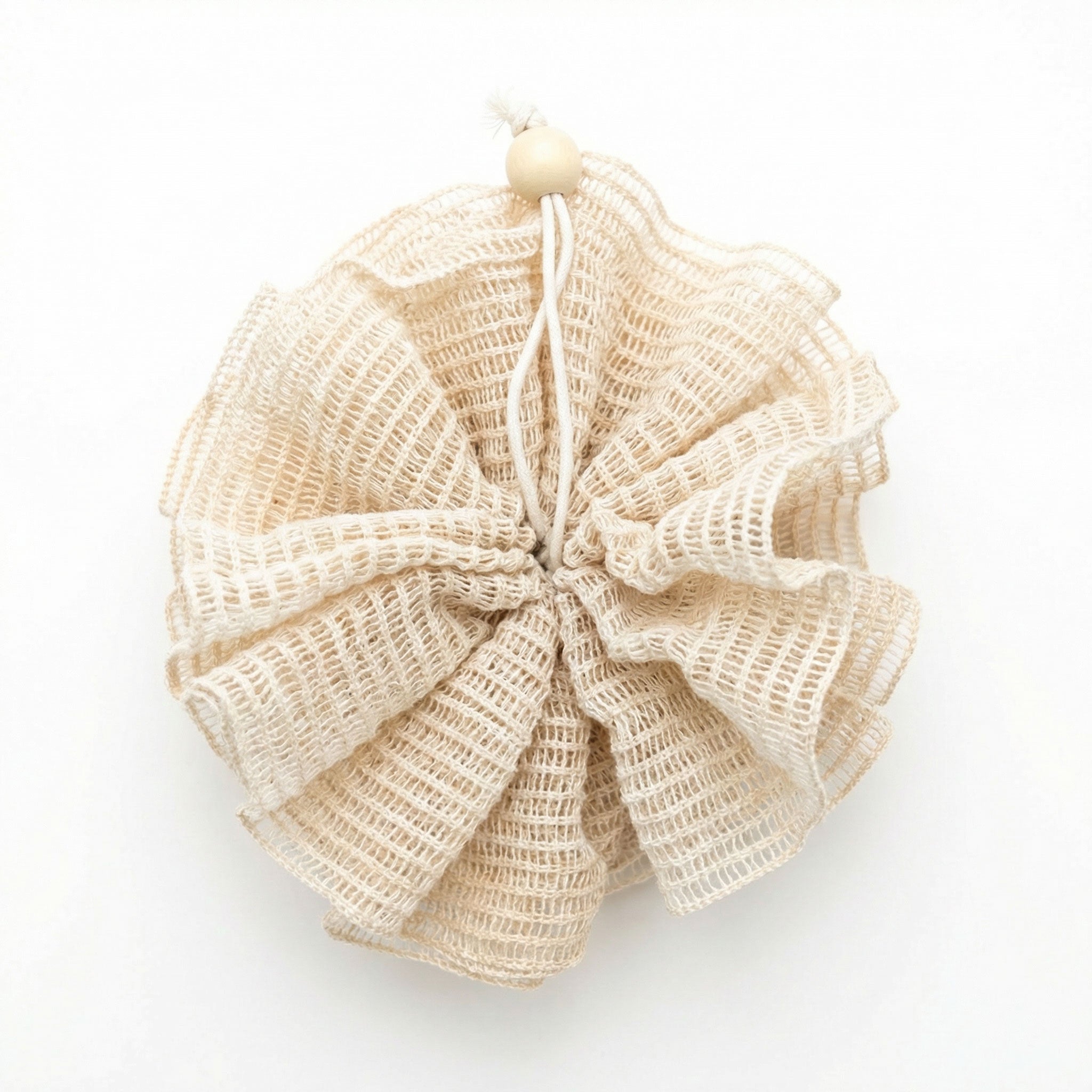 Beige bath pouf on a white background
