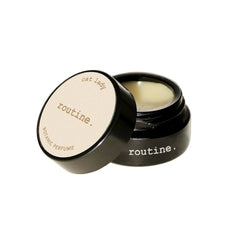 Routine Cat Lady solid perfume - black glass jar with cream label open showing smooth balm texture - natural coconut pineapple vanilla scented moisturizing perfume