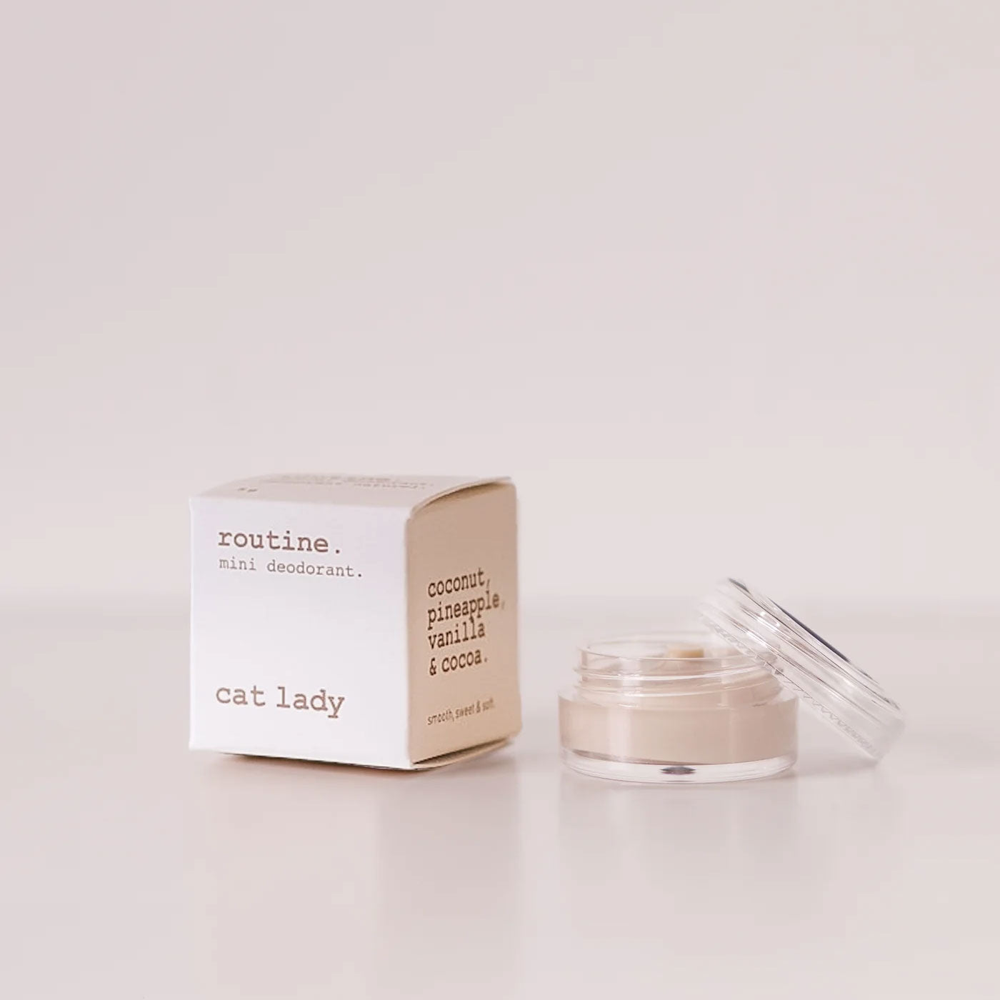Routine Cat Lady vegan deodorant mini - cream cardboard box beside open glass jar showing light cream deodorant