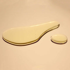 Close-up of golden-amber routine body oil texture showing smooth, clear botanical oil consistency with single drop demonstrating lightweight viscosity.