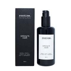 Routine Johnny's Cash Natural Mist - detailed product view showing black spray bottle with white label next to black packaging displaying woodsy fresh classic fragrance description for masculine daily use