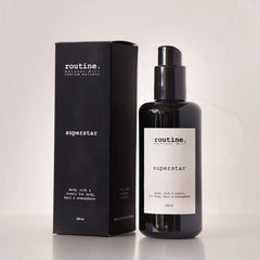 Routine Superstar Natural Mist - black glass bottle with spray pump next to matching black cardboard packaging showing 200ml size - multi-use botanical formula for body, hair and atmosphere
